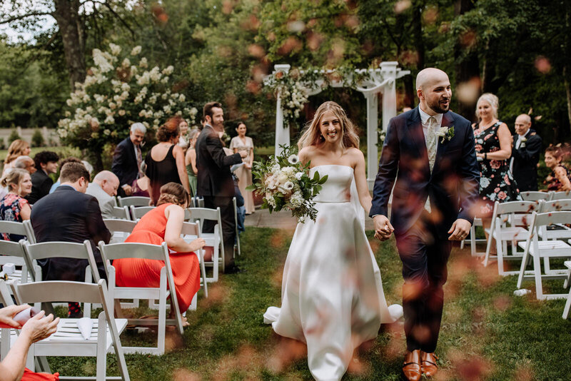 bride and groom holding hands and smiling