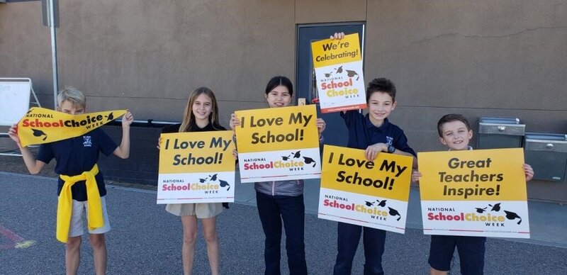 Children holding up National School Choice Week Signs