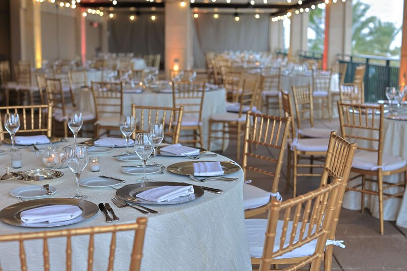 corporate events company dinner layout with chiavari chairs and chic dinnerware