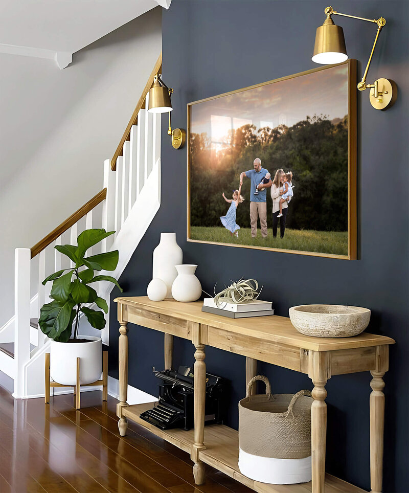 A large, framed image of a family displayed in an entry way at their home