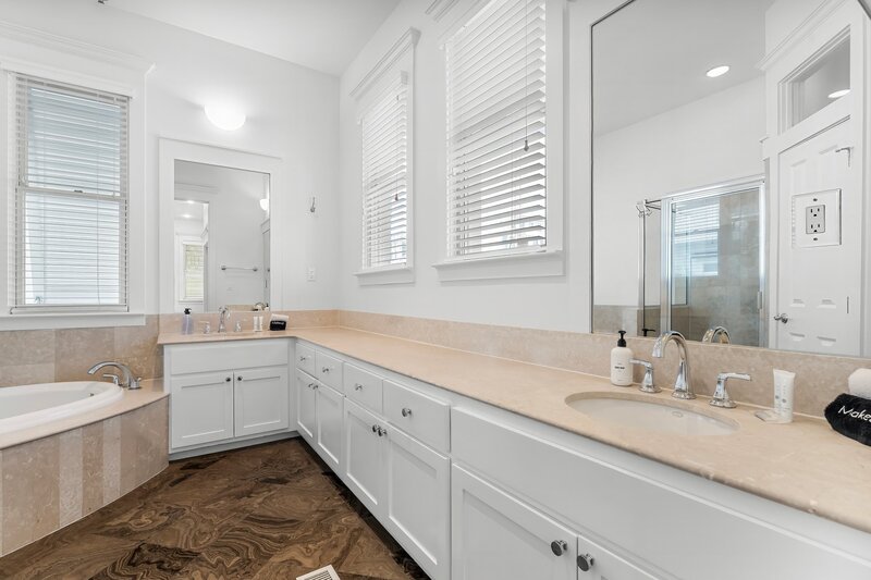 Spacious double sink bathroom with natural light in Panama City Beach condo.