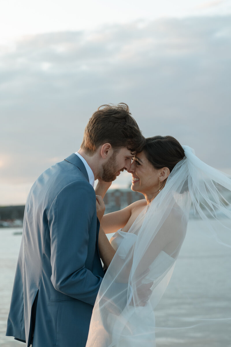 Bride and groom kissing at sunset, Newport wedding