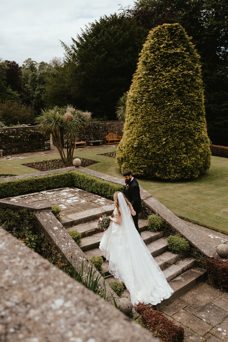 married couple walk the gardens at Glenapp Castle