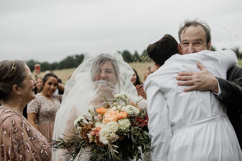 A bride and groom celebrate with family on their wedding day. Pennsylvania Elopement Photographer