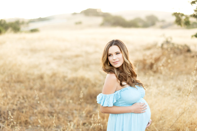 pregnant mom blue dress field