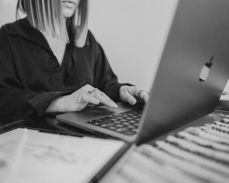 Erika of roen creative studio working on creative brand design on laptop