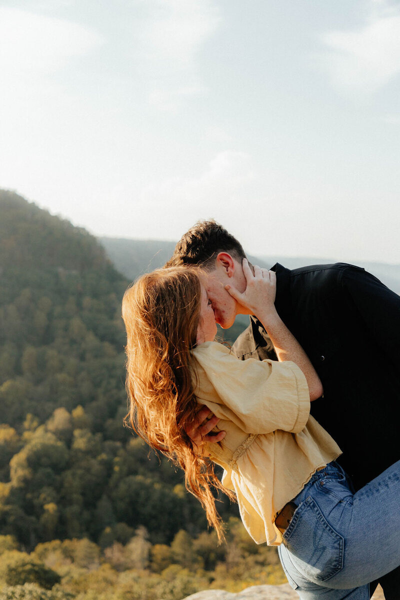 couple kissing in mountains