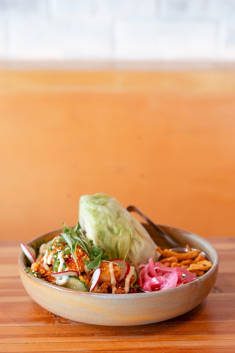 Delicious lettuce wrap bowl from the Barley Merchant on a table