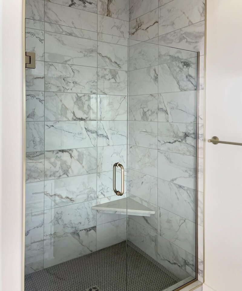 Custom shower with white and gray marble tile.