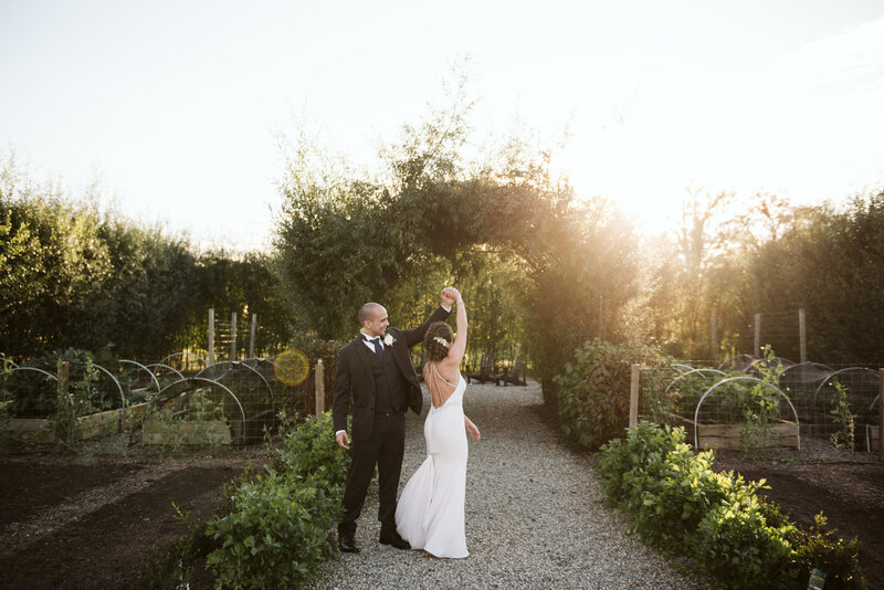 bride and groom dancing in garden at sunset at Zingerman's Cornman Farms in Michigan