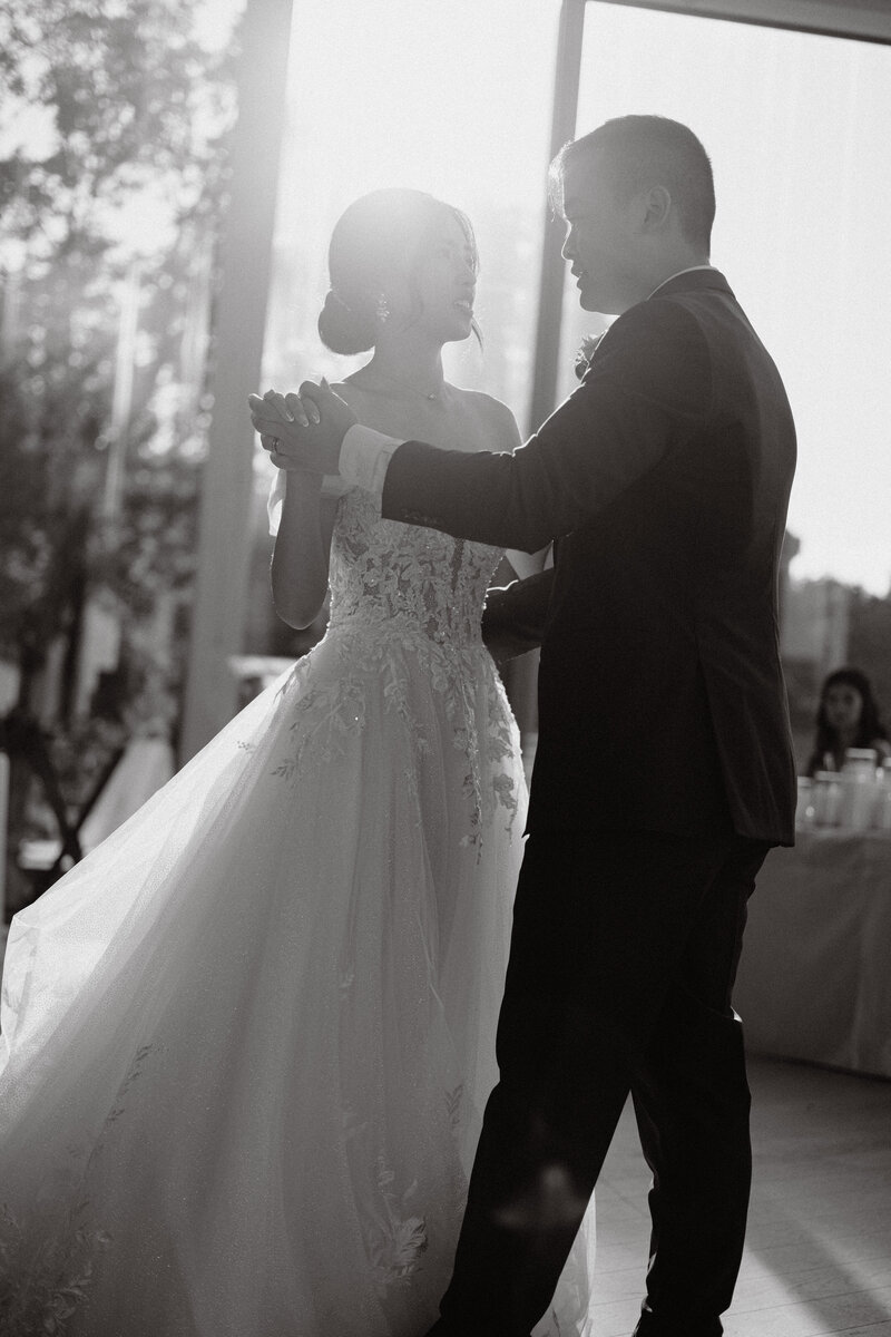 Husband and wife seal the deal with their first kiss amongst a backdrop of greenery