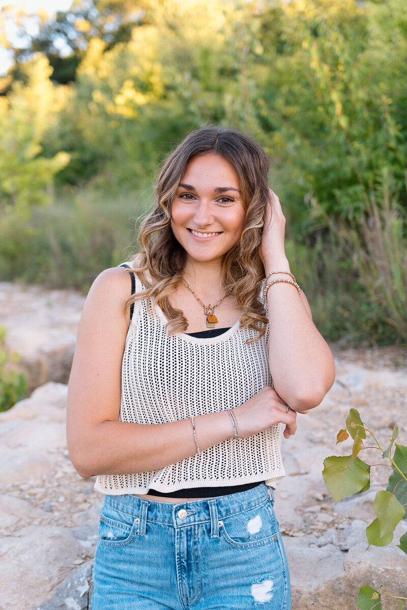 girl poses for senior photos in kansas city