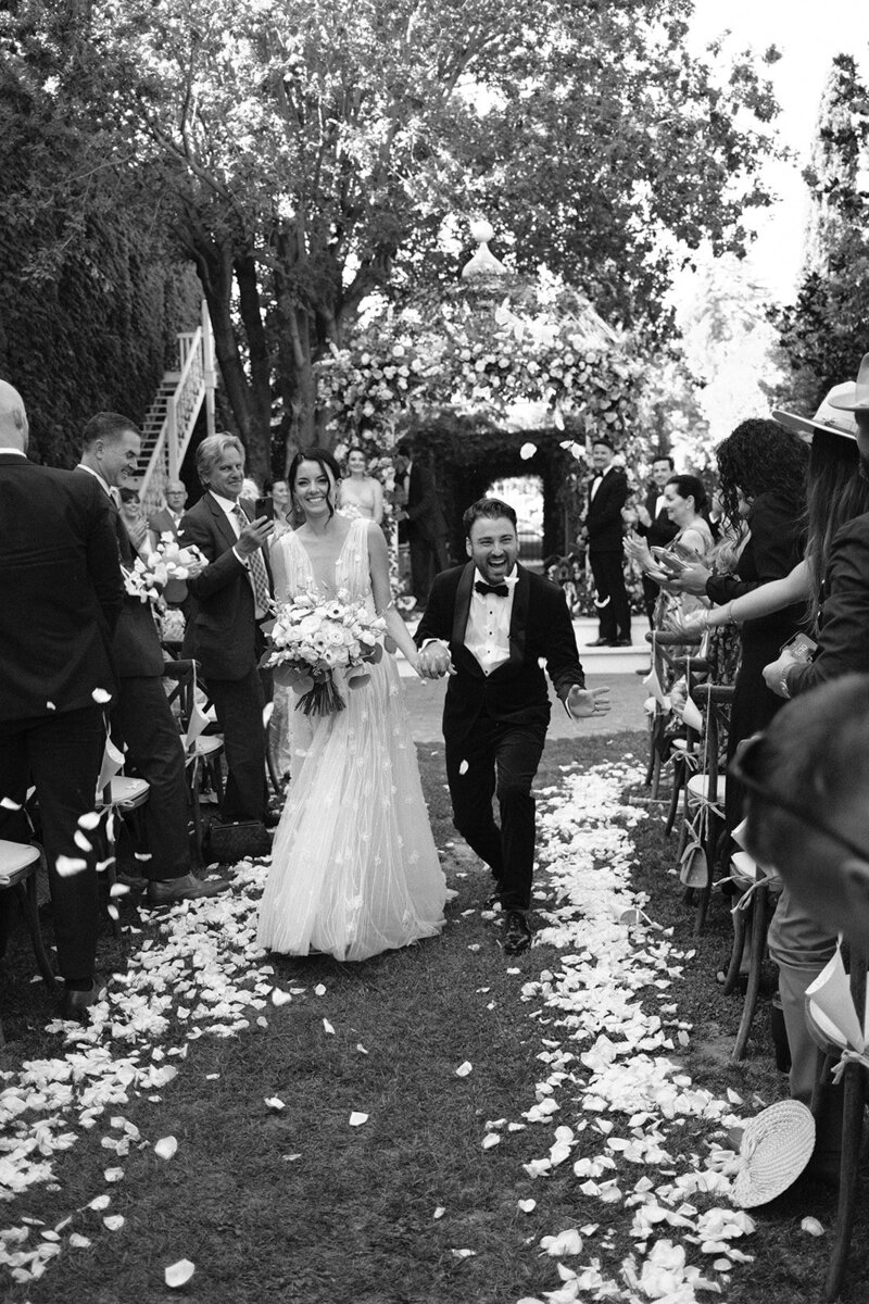 bride and groom standing outside of venue