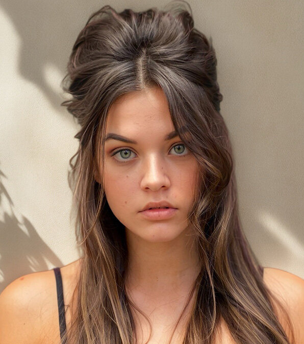 Long brunette hair styled in a half-updo with soft waves, showcasing advanced scissor skills and cutting techniques.