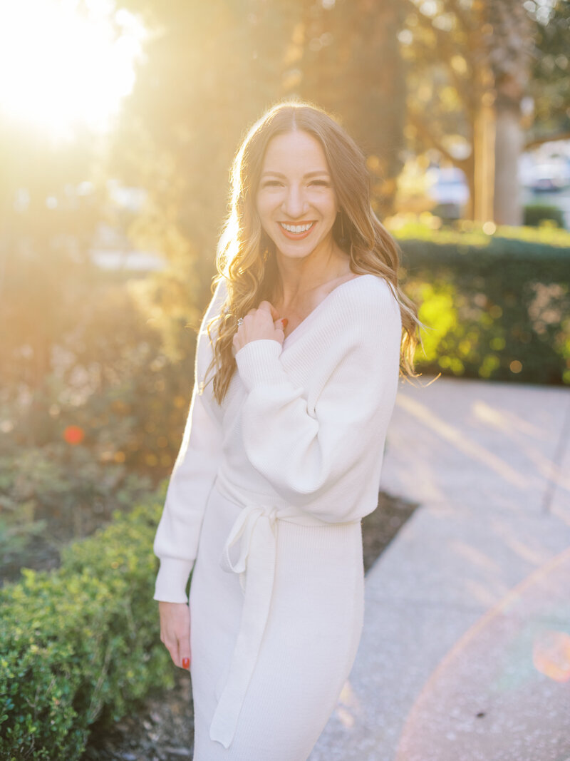 a photographer stands in the sunset for a headshot