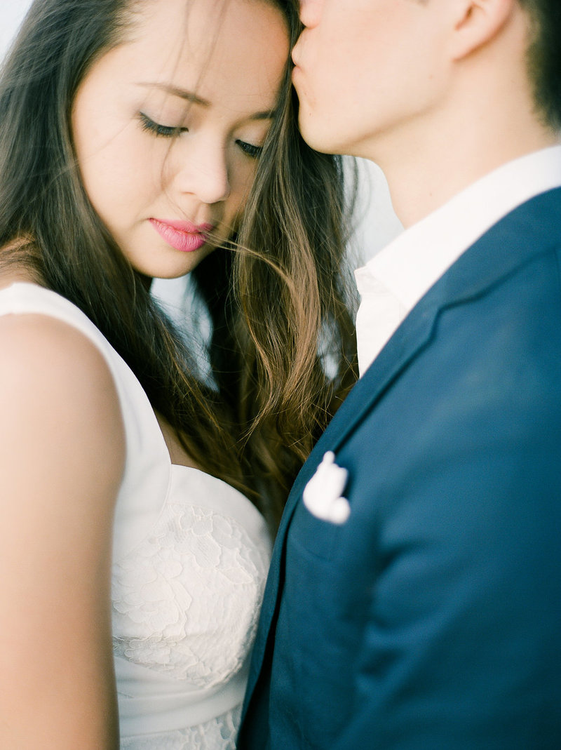 Close up of groom kissing bride wedding day session