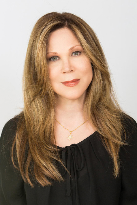 Headshot of Erika Robison, a woman with blonde hair wearing a black blazer and black shirt.