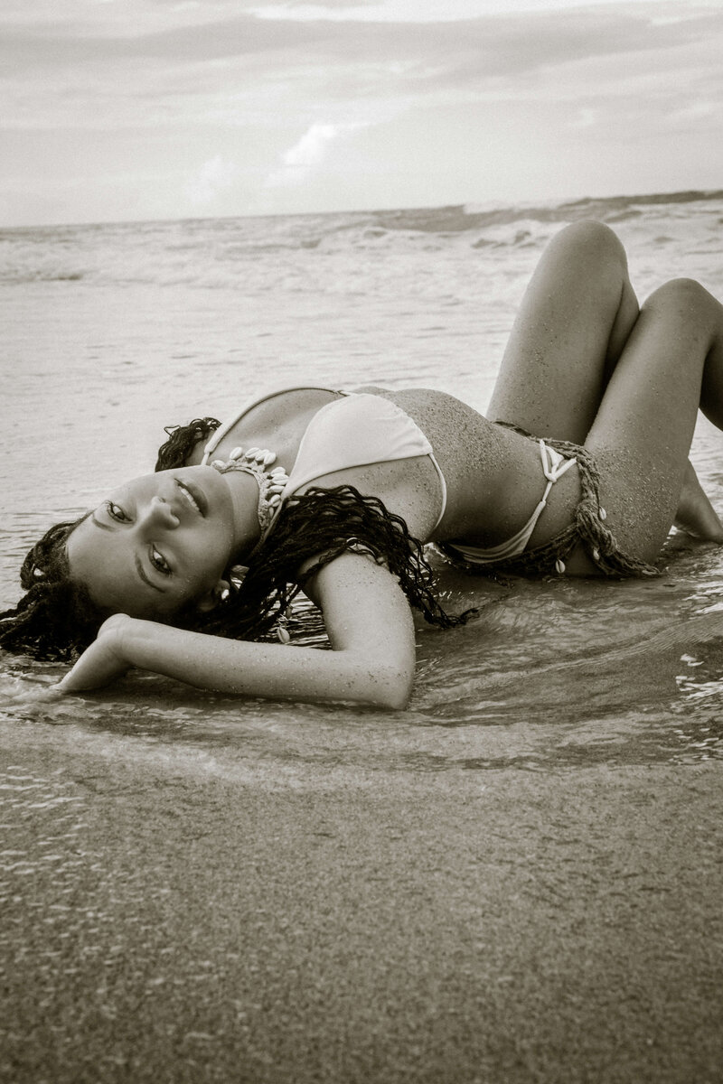 Girl laying on the beach  modeling