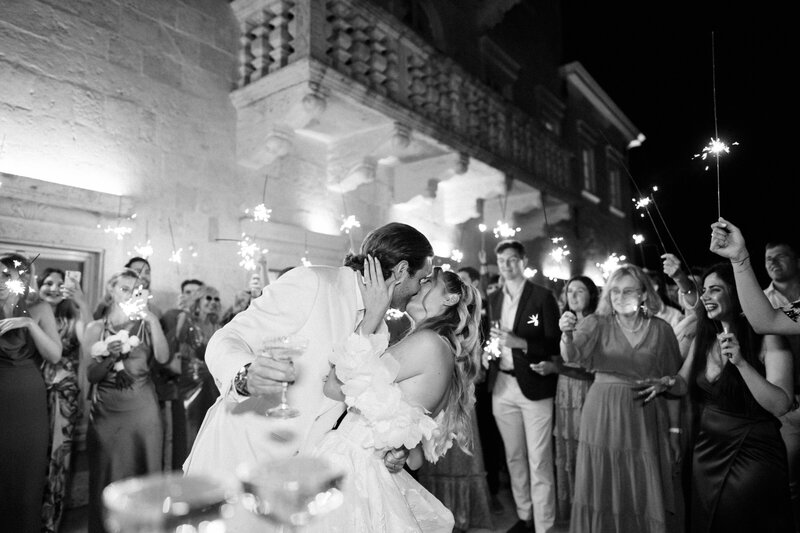 Emotional black and white photo of newlyweds kissing during first dance, captured by wedding photographer in Toronto with a documentary style