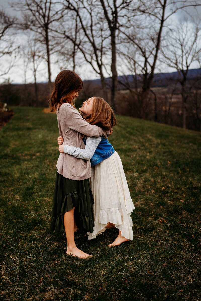 Sisters embracing and hugging outside