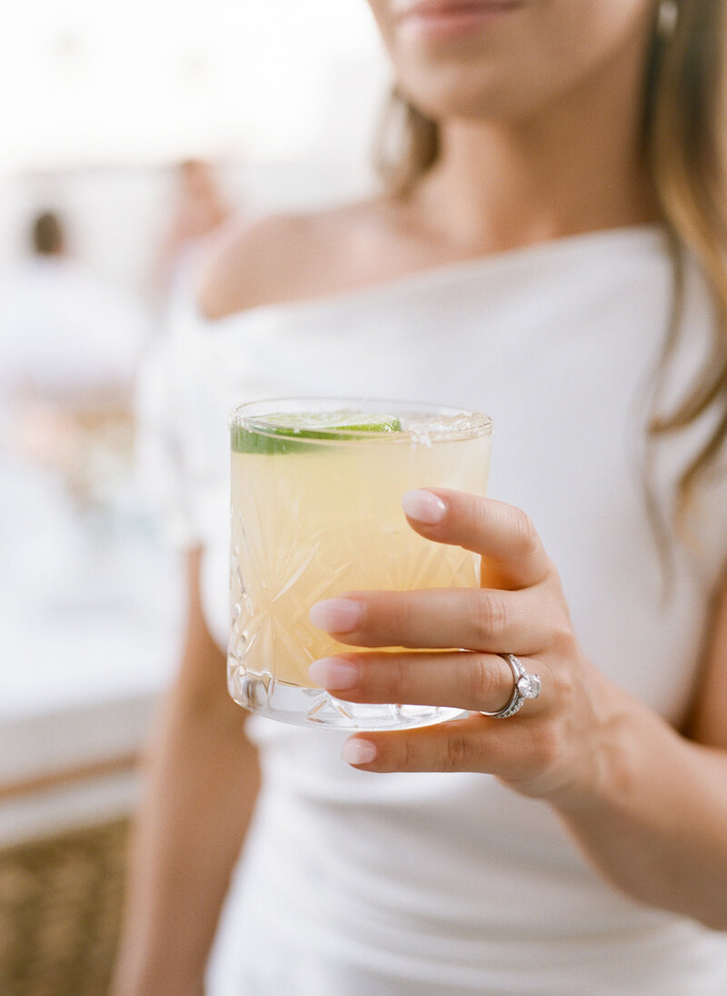 bride holding drink in glass