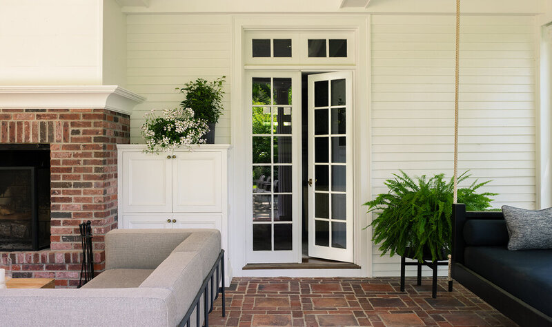 Boston interior designer creates a modern patio space at a historic Concord home, blending timeless architecture with contemporary outdoor living.