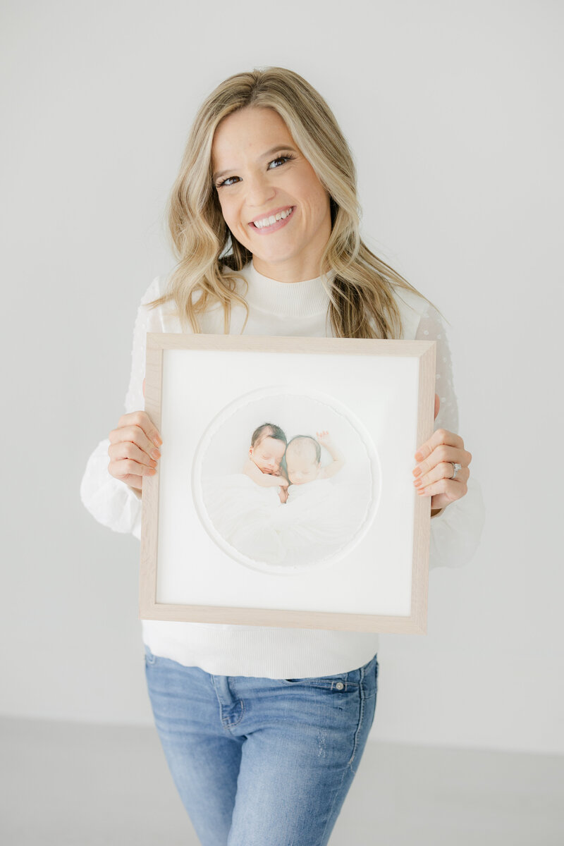 Kimberly holding a framed heirloom portrait