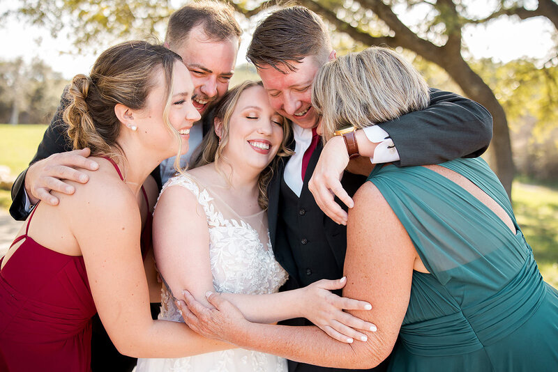 Bride and Groom celebrate with their family at the Creek Haus wedding venue in Dripping Springs, Texas.