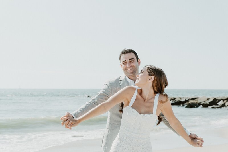 Bride and groom dancing on beach at elopement in San Diego
