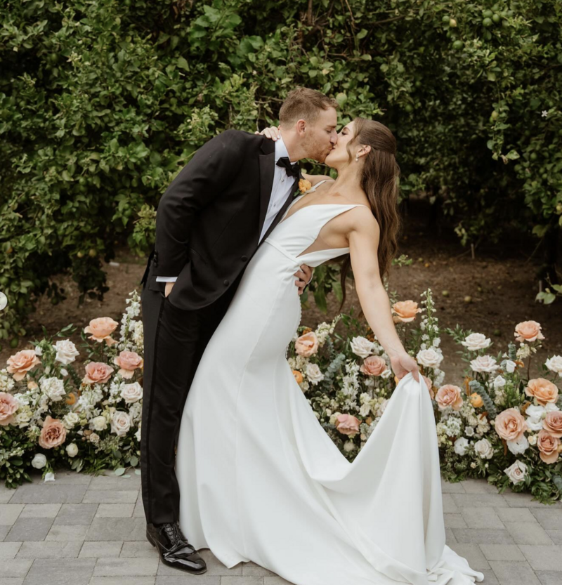 black and white photo of bride holding bouquet under her veil