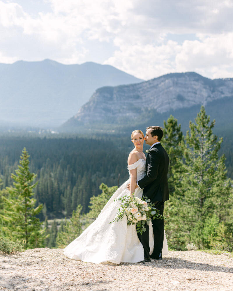 A romantic photograph of a bride and groom during their portrait session near Buffalo Mountain Lodge in Banff, surrounded by stunning natural beauty.