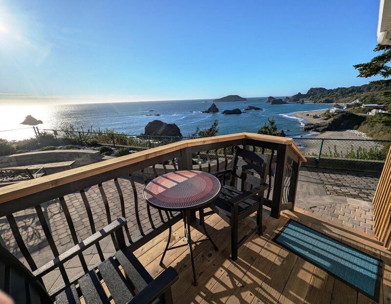Deck with table and chairs and an ocean view