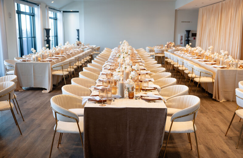 Elegant tablescape at the Riggs Hotel in Washington, DC, featuring the Pantone Color of the Year, mocha mousse, with amber and brown glass votives, cream candles, and beige roses. 