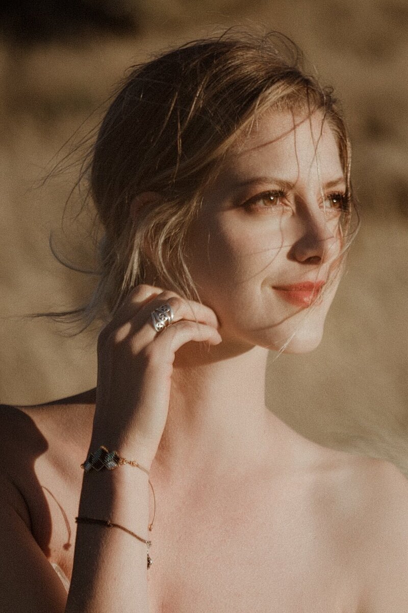 A golden light outdoor photoshoot of a woman wearing a couture dress.