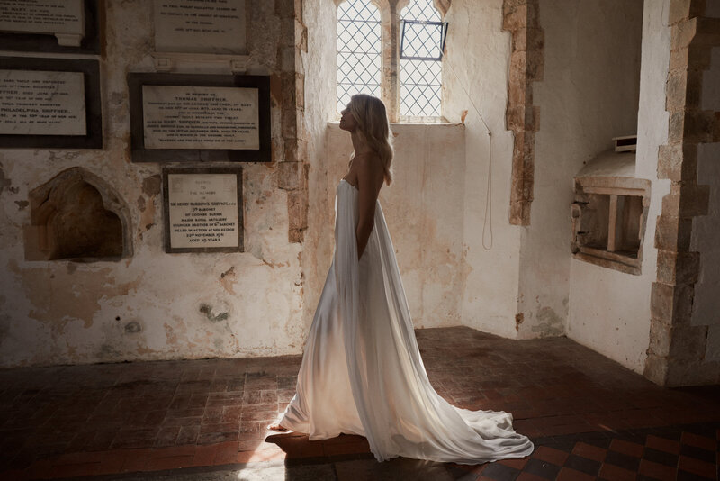 Bride wearing customizable silk wedding seperate, mounted on silk corset, in church