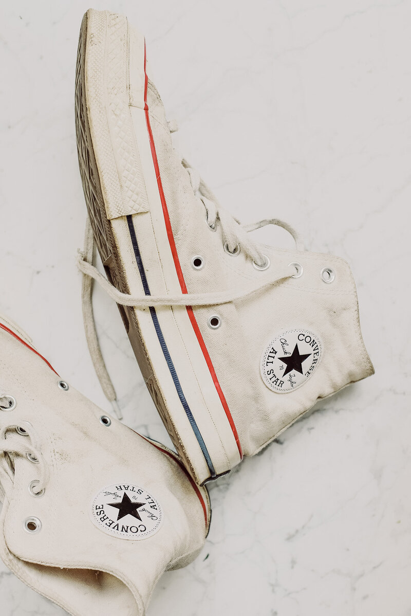 a pair of white converse shoes