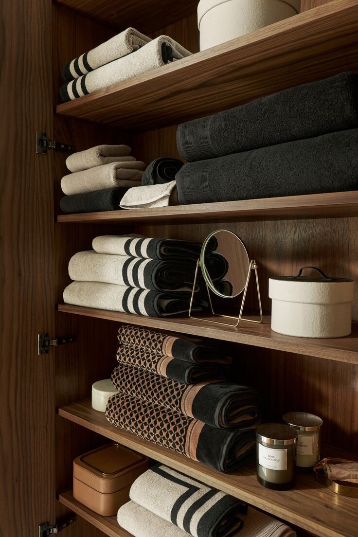 Towels and home amenities on a shelf