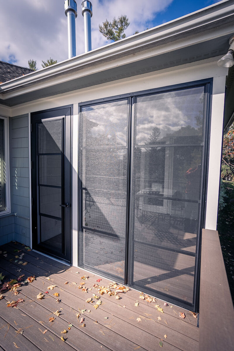 Exterior view of three-season porch with screen-and-vinyl windows and door. 