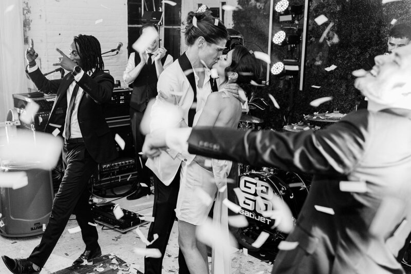 A lively wedding reception in New Jersey, where the bride and groom share a passionate dance amid a high-energy celebration with a live band.