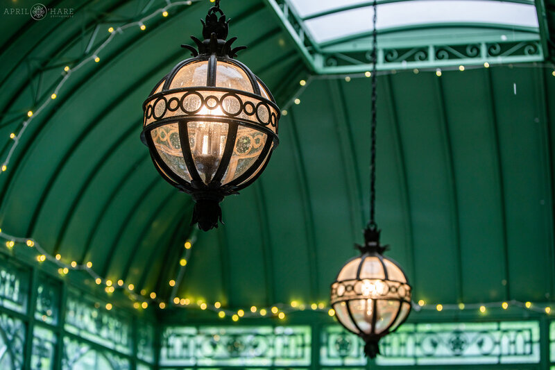Detail photo of the vintage style globe pendant lights inside of the Green Solarium at Denver Botanic Gardens