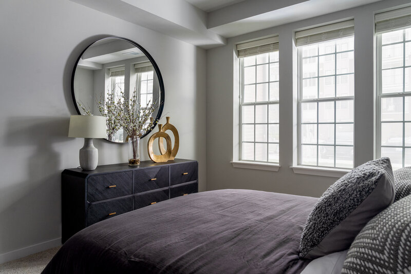 model home commercial design of a bedroom by Gracious Home Interiors