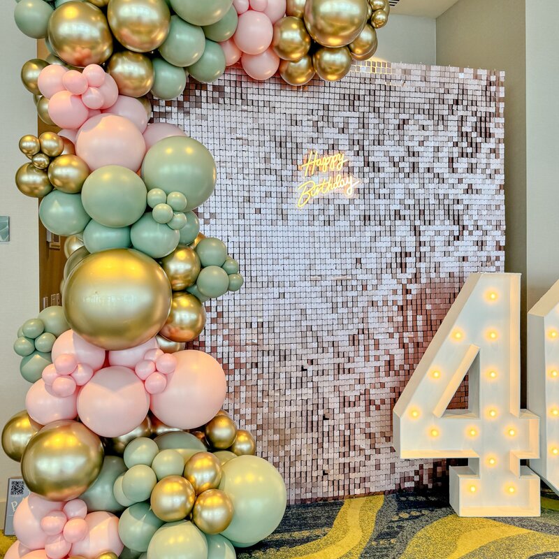 pink, green, gold balloons with shimmer wall and marquee number