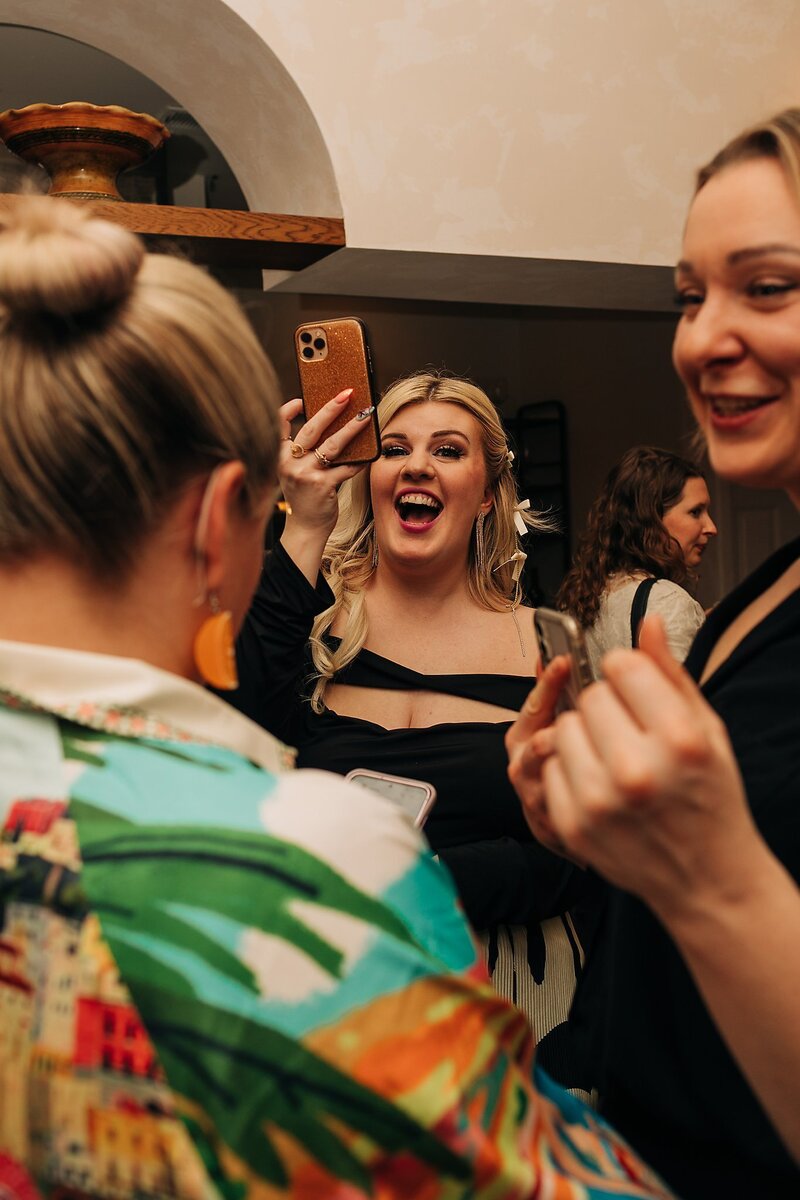 Friends toasting and celebrating during Dart Collective Chicago launch at Lou Lou by Lola Cafe