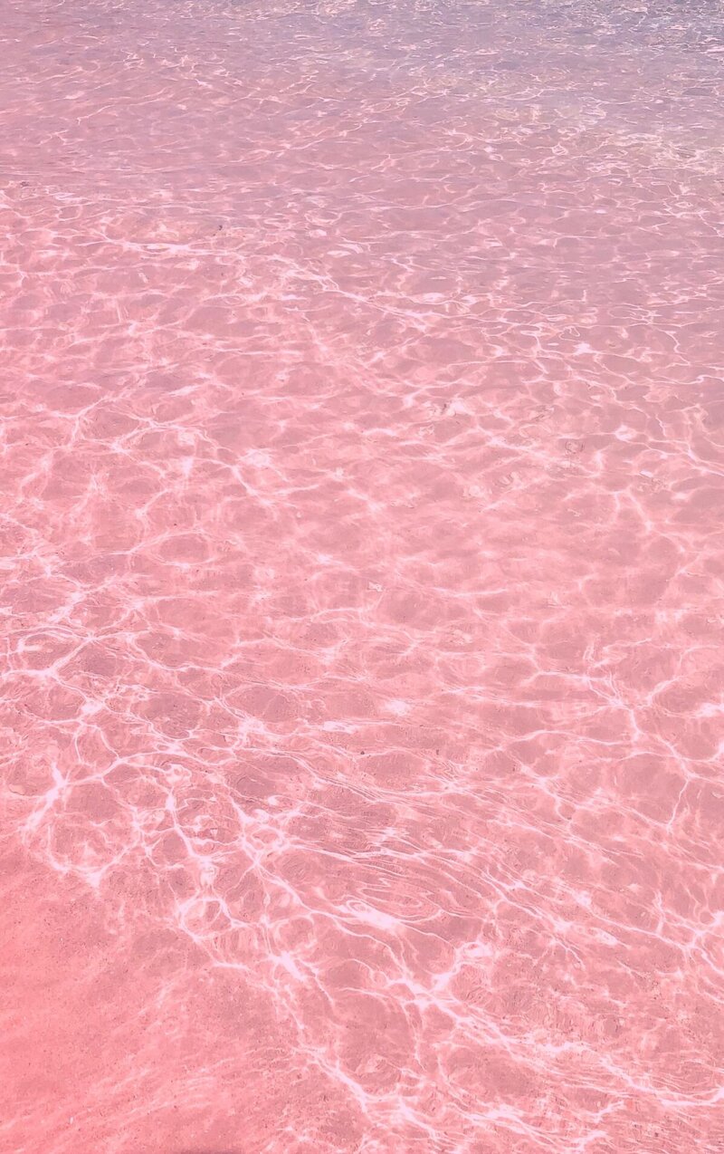 Photo of clear water beach over pink sand representing the calmness you can experience after participating in online betrayal trauma recovery program with a California therapist who specializes in trauma betrayal and affair recovery.