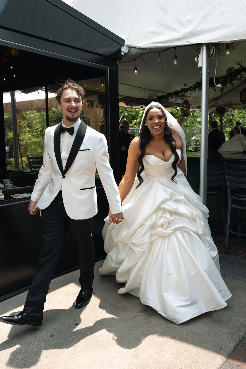 Bride and groom sharing a joyful, intimate kiss under the veil during their wedding ceremony