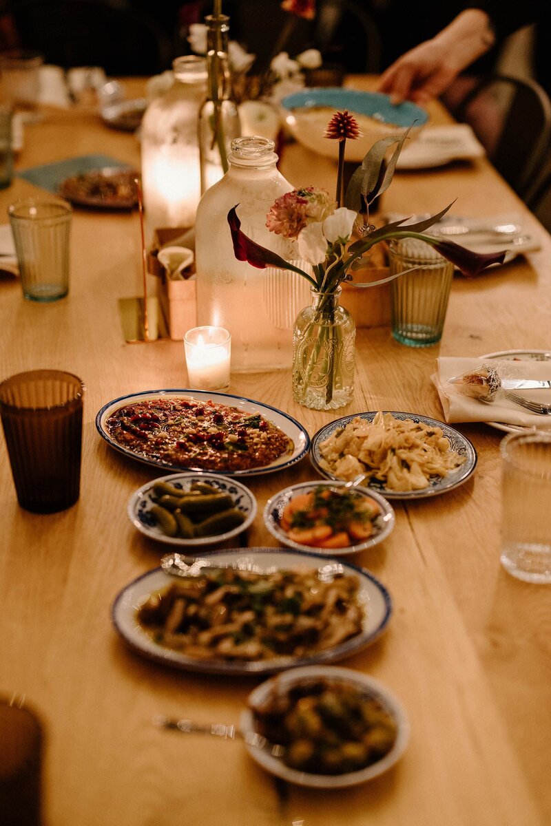 Small plates of food laid out on a wooden table 