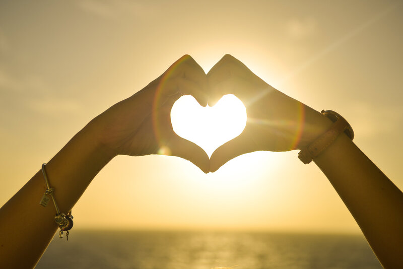 Canva - Two People Forming Heart Sign to Sun