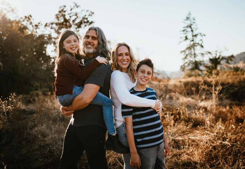 Family standing in golden hour light with mountain backdrop — origin story of the Leaving Main Street expat travel blog