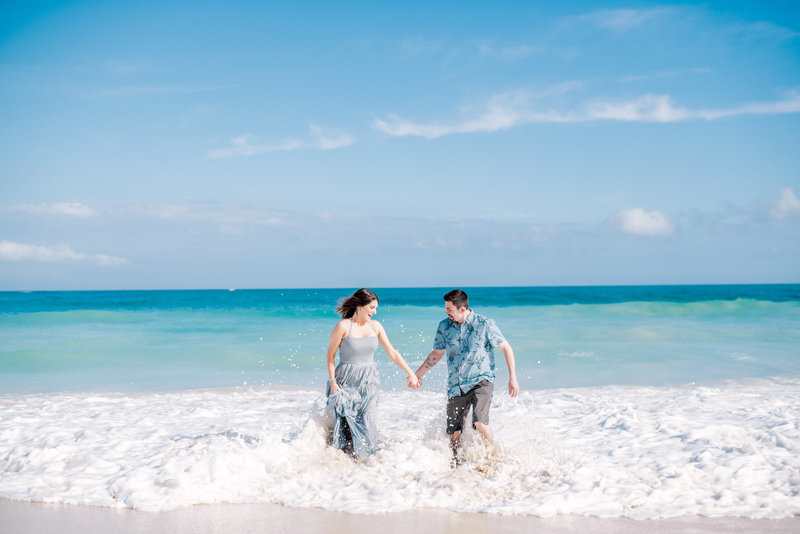 A lovely couple wearing blue colors that match the sky and the sea at Maui Beach.