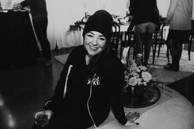 Black and white photo of a long haird woman laughing